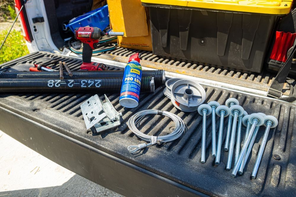 Technician safely servicing a garage door torsion spring